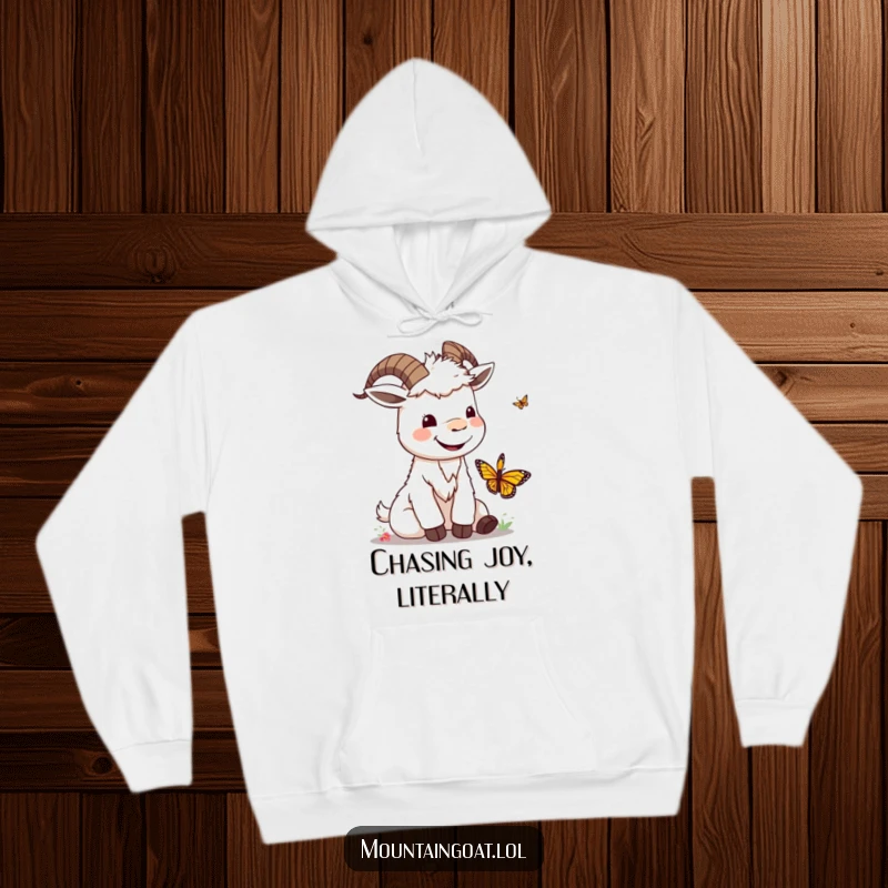 Funny kawaii mountain goat with a silly smile playing with a butterfly, featured on a cozy and cheerful hoodie.