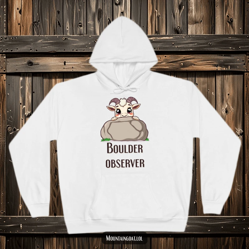Funny curious mountain goat hoodie, peeking over a large boulder with wide pupils, providing warmth and a sense of playful discovery.
