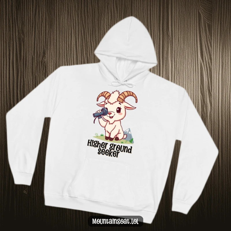 Funny mountain goat hoodie shows a cheerful goat character using a spyglass to survey a distant mountain peak, offering cozy exploration.