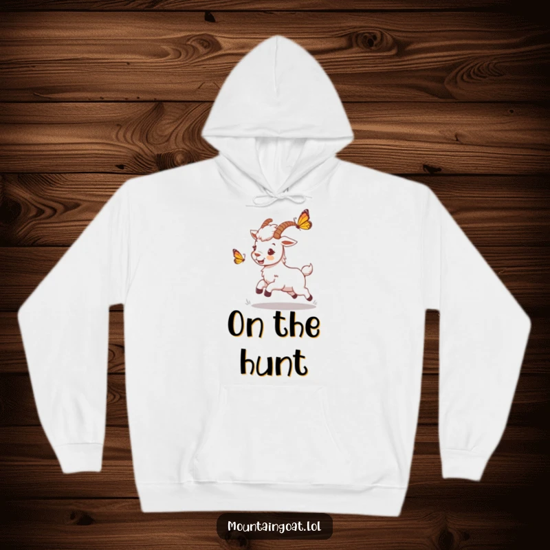 Funny mountain goat hoodie featuring a playful character chasing a butterfly, designed for comfort and to evoke feelings of lighthearted joy.