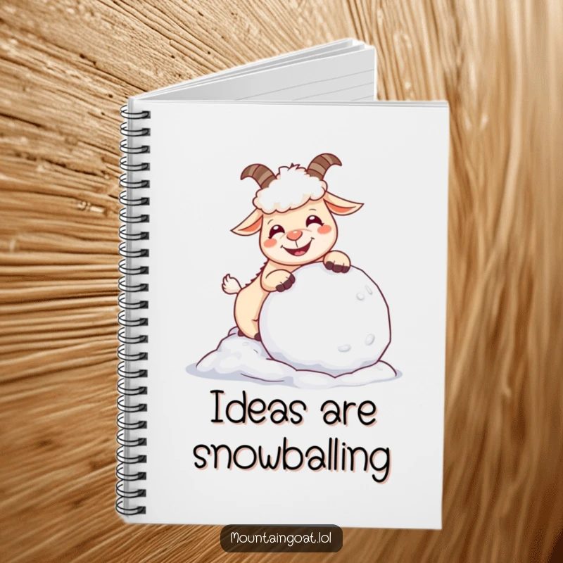 Funny giggling mountain goat playing with a snowball, featured on a vibrant notebook cover for creative writing and notes.